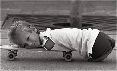 Nick at a young age, resting on a skateboard (thesun.co.uk)